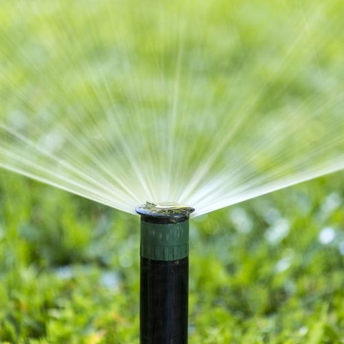 A Picture of an Automatic Irrigation System Spraying Water.