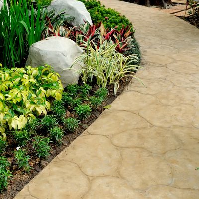 A Picture of a Stone Walkway in a Garden.